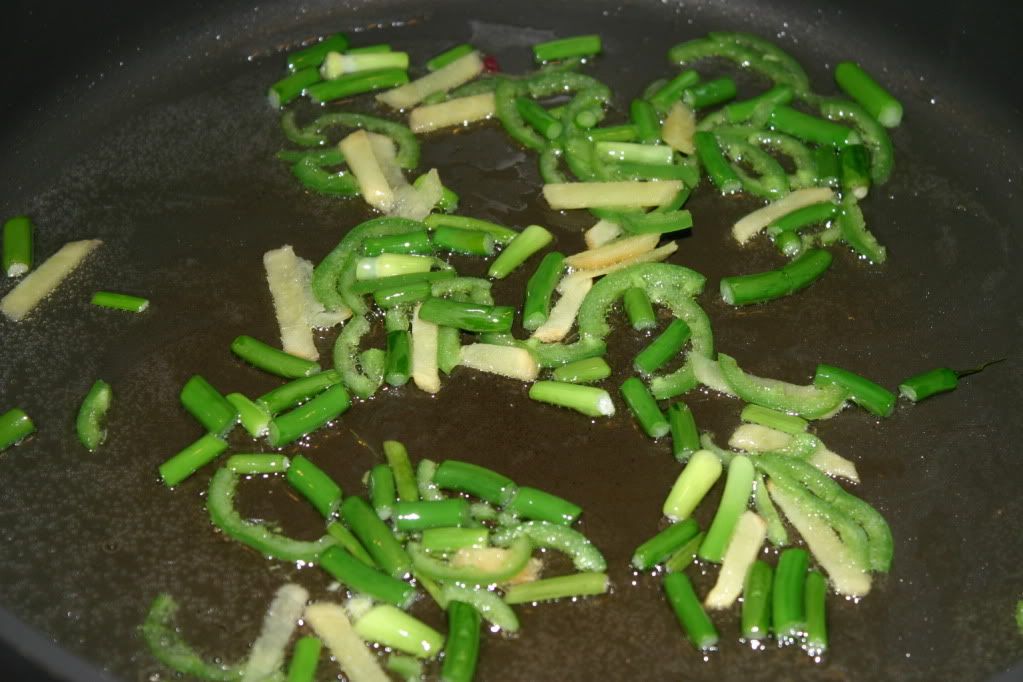 Frying the ginger, chile, and garlic scapes